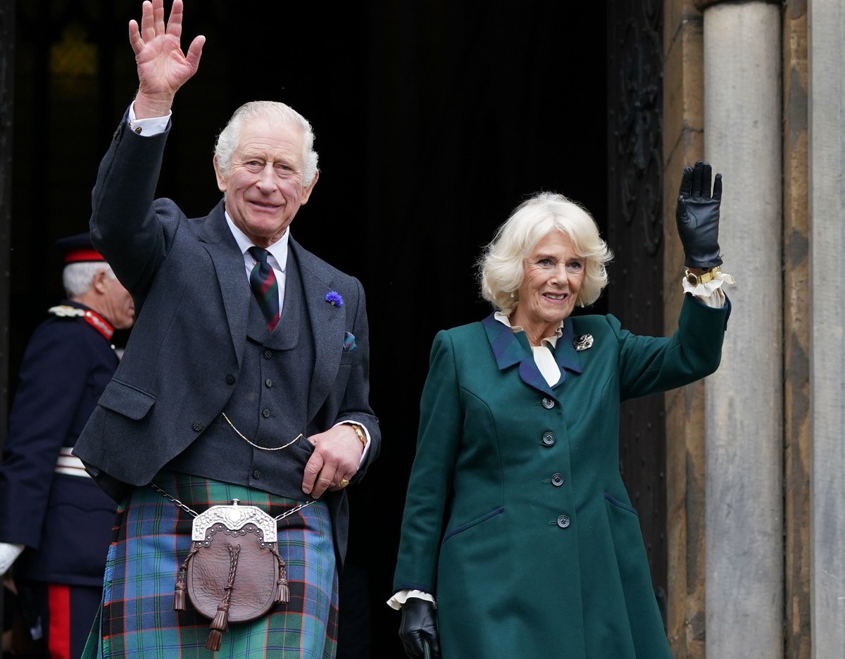 Britain's King Charles III and Camilla, the Queen Consort, wave as they leave Dunfermline Abbey, after a visit to mark its 950th anniversary, and after attending a meeting at the City Chambers in ...