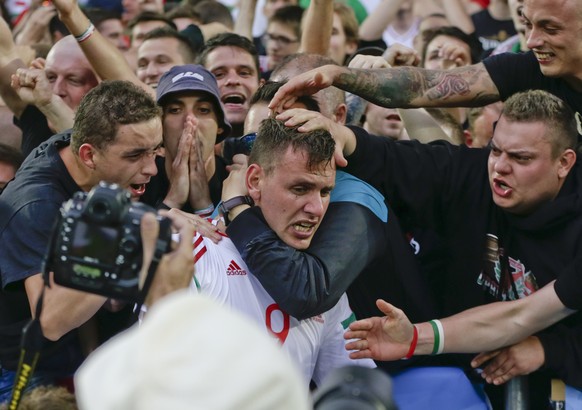 Hungary&#039;s Adam Szalai celebrates with fans after scoring his side&#039;s first goal during the Euro 2016 Group F soccer match between Austria and Hungary at the Nouveau Stade in Bordeaux, France, ...