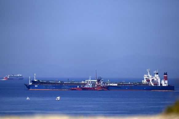 The Pegas tanker, that has recently changed its name to Lana, foreground, is surrounded by other vessels off the port of Karystos on the Aegean Sea island of Evia, Greece, Friday, May 27, 2022. The cr ...