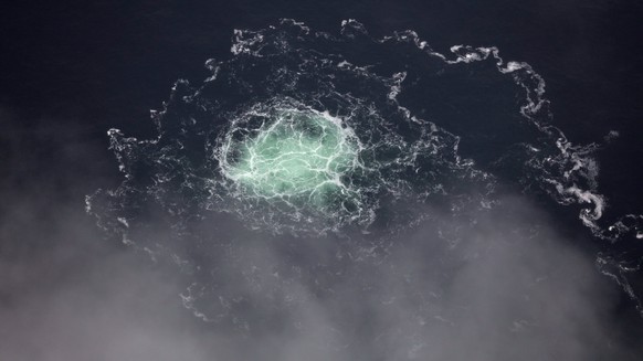 epa10213304 A handout photo made available by the Swedish Coast Guard and taken from the Swedish Coast Guard aircraft shows the small gas leak from Nord stream 2 in the Swedish economic zone in the Ba ...