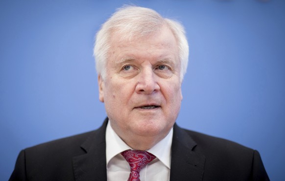 German Interior Minister Horst Seehofer arrives for a press conference where he presents the 2017 German crime statistic in Berlin Tuesday, May 8, 2018. (Kay Nietfeld/dpa via AP)