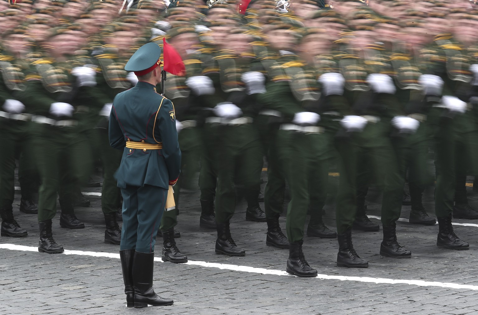 In this photo taken with long time exposure, Russian soldiers march toward Red Square during the Victory Day military parade in Moscow, Russia, Sunday, May 9, 2021, marking the 76th anniversary of the ...