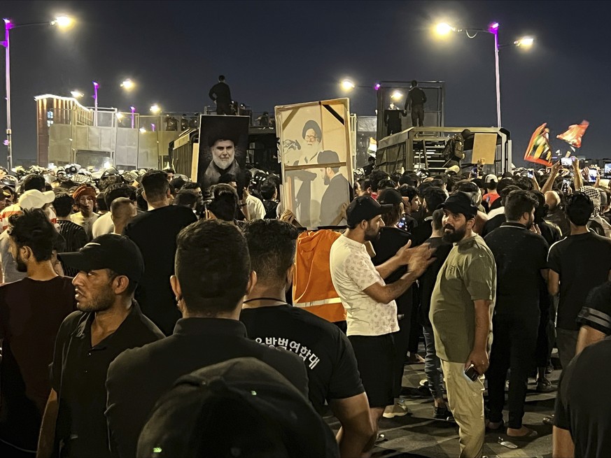 Protesters gather in Baghdad&#039;s Tahrir Square, carrying Iraqi flags and images of influential Iraqi Shiite cleric and political leader Muqtada al-Sadr, Saturday, July 22, 2023, following reports o ...