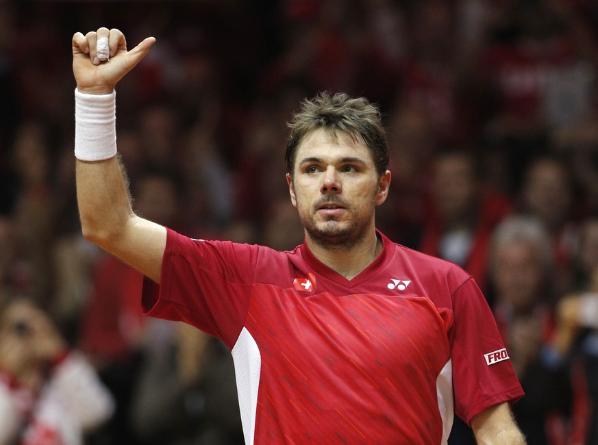 Switzerland's Stanislas Wawrinka waves after defeating France's Jo-Wilfried Tsonga during the Davis Cup final in Lille, northern France, Friday, Nov.21, 2014. Wawrinka won 6-1, 3-6, 6-3, 6-2 ...