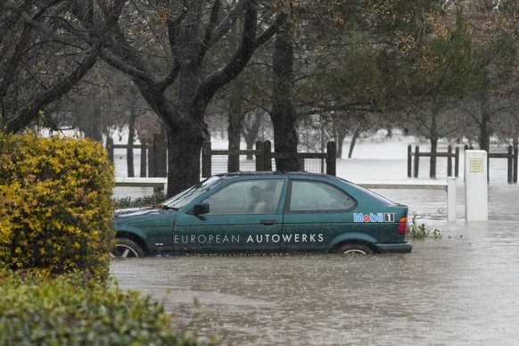 A car lies semi submerged in flood waters at Camden on the outskirts of Sydney, Australia, Monday, July 4, 2022. More than 30,000 residents of Sydney and its surrounds have been told to evacuate or pr ...