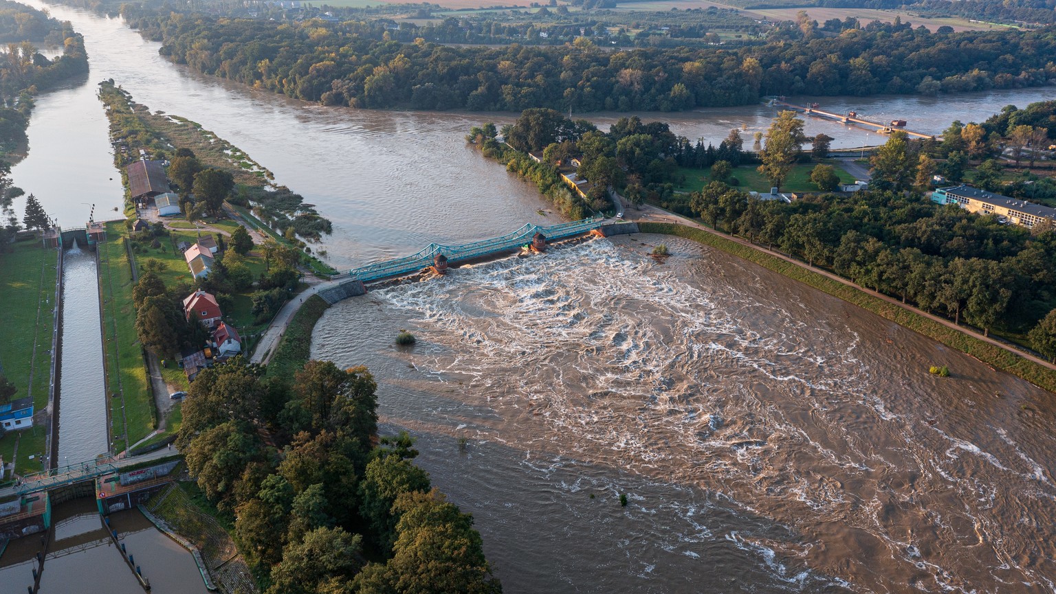 epa11613258 An aerial picture taken with a drone shows the surging waters of the Odra river, following heavy rains brought by Storm Boris, in Wroclaw, southwestern Poland, 19 September 2024. Since 13  ...