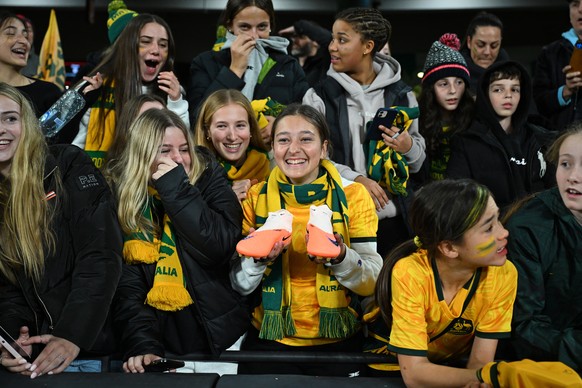 epa10745796 An Australia&#039;s fan holding a pair of shoes (C) reacts during a &#039;Send Off Match&#039; between Australia and France, ahead of the FIFA Women&#039;s World Cup 2023, at Marvel Stadiu ...