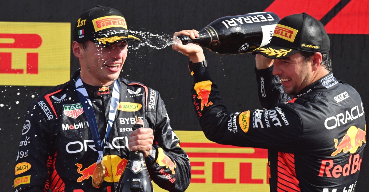 epa10838101 Winner Dutch driver Max Verstappen (L) of Red Bull Racing celebrates on the podium with second placed Mexican driver Sergio Perez of Red Bull Racing after the Italian Formula One Grand Pri ...