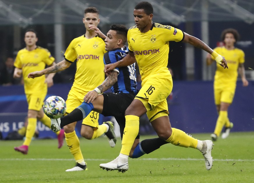 Inter Milan's Lautaro Martinez, centre, controls the ball between Dortmund's Julian Weigl, left, and Dortmund's Manuel Akanji, right, during the Champions League, Group F soccer match b ...