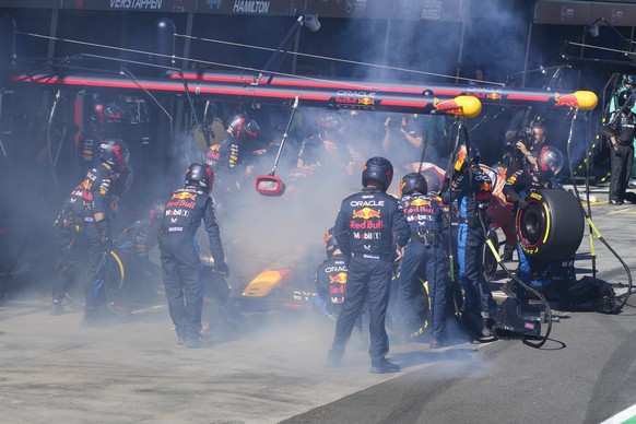 Mechanics work to put out a fire in Red Bull driver Max Verstappen of the Netherlands' car during the Australian Formula One Grand Prix at Albert Park in Melbourne, Australia, Sunday, March 2 ...