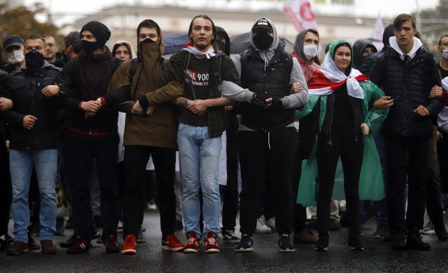 Belarusian opposition supporters block a street during a rally to protest the official presidential election results in Minsk, Belarus, Sunday, Oct. 11, 2020. Belarus&#039; authoritarian president Ale ...