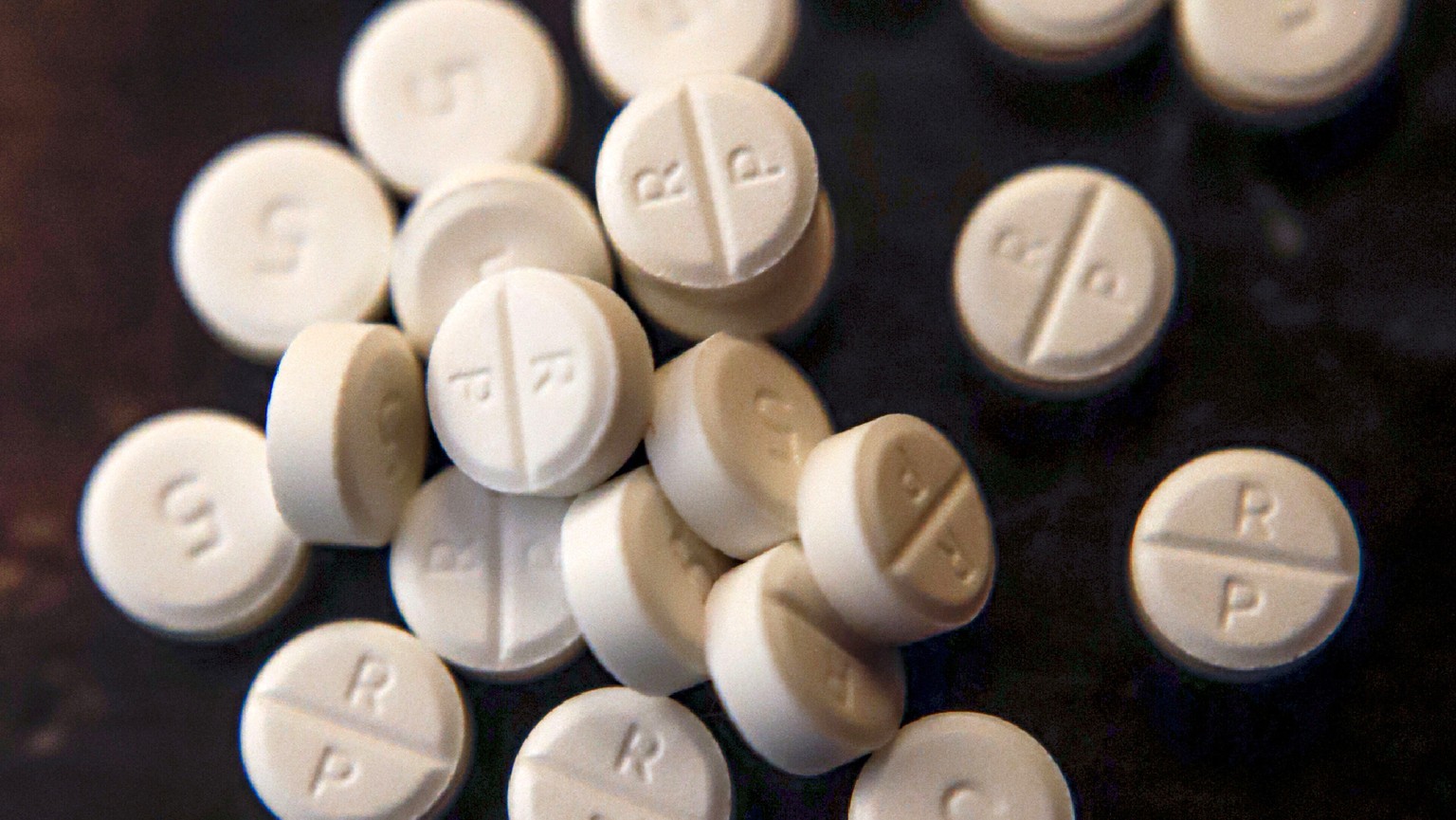 FILE - This June 17, 2019, file photo shows 5-mg pills of Oxycodone. Lawsuits filed by two Ohio counties against retail pharmacy chains claiming their opioid dispensing practices flooded communities w ...