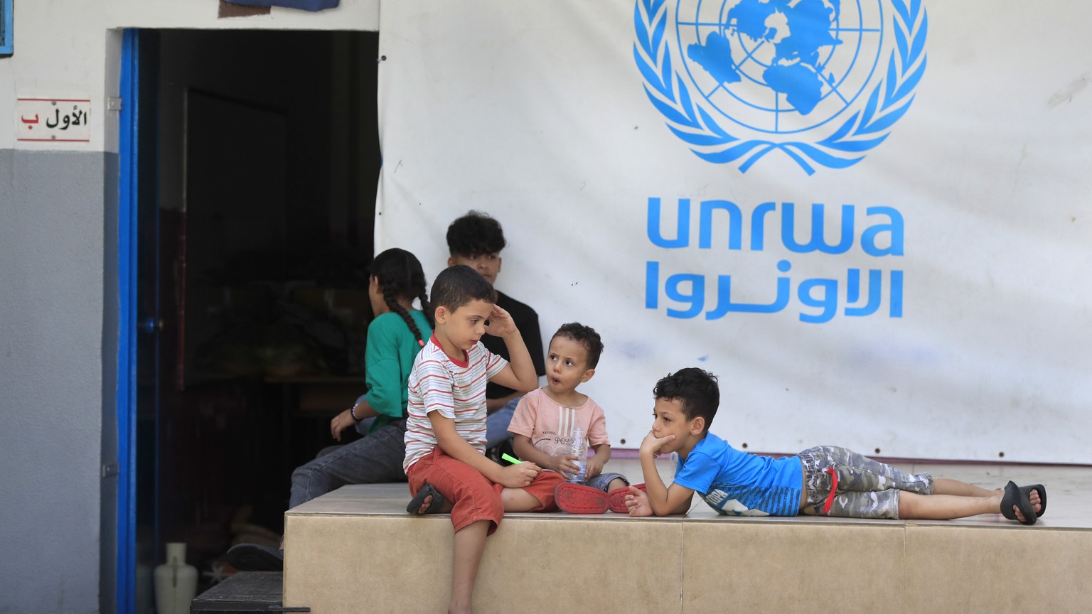 FILE - Palestinian children who fled with their parents from their houses in the Palestinian refugee camp of Ein el-Hilweh, gather in the backyard of an UNRWA school, in Sidon, Lebanon, Sept. 12, 2023 ...