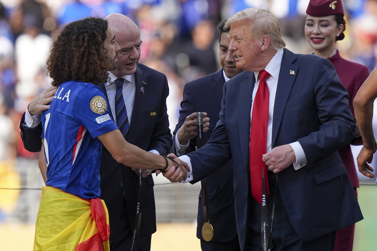 President Donald Trump, right, greets Chelsea's Marc Cucurella during the trophy ceremony after the Club World Cup final soccer match between Paris Saint-Germain and Chelsea in East Rutherford, N ...