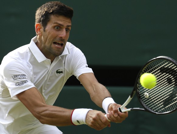 Serbia&#039;s Novak Djokovic returns the ball to Ugo Humbert of France in a men&#039;s singles match during day seven of the Wimbledon Tennis Championships in London, Monday, July 8, 2019. (AP Photo/K ...