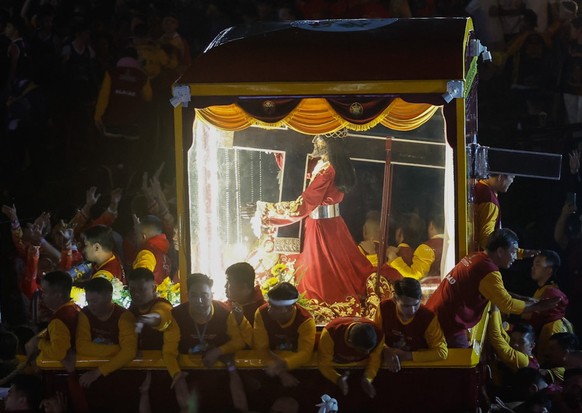 epa11065060 Catholic devotees participate in the early morning procession marking the feast day of the Black Nazarene at the Quirino Grandstand park in Manila, Philippines, 09 January 2024. The Black  ...
