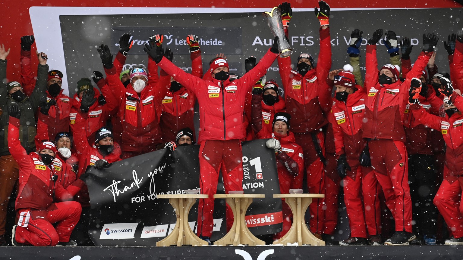 Urs Lehmann, president of the Swiss Ski team, center, celebrates with the trophy during the award ceremony of the nations cup competition at the FIS Alpine Skiing World Cup finals, in Lenzerheide, Swi ...