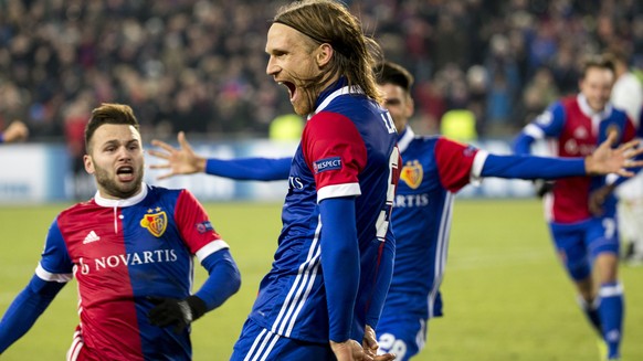 Basel&#039;s Michael Lang, center, celebrates with his teammate Basel&#039;s Renato Steffen, left, the first goal during the UEFA Champions League Group stage Group A matchday 5 soccer match between S ...