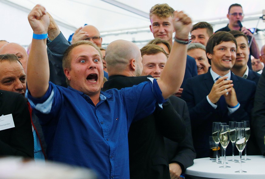 People react to first exit polls during the Mecklenburg-Vorpommern state election at the anti-immigrant Alternative for Deutschland (AfD) post election venue in Schwerin, Germany, September 4, 2016. R ...