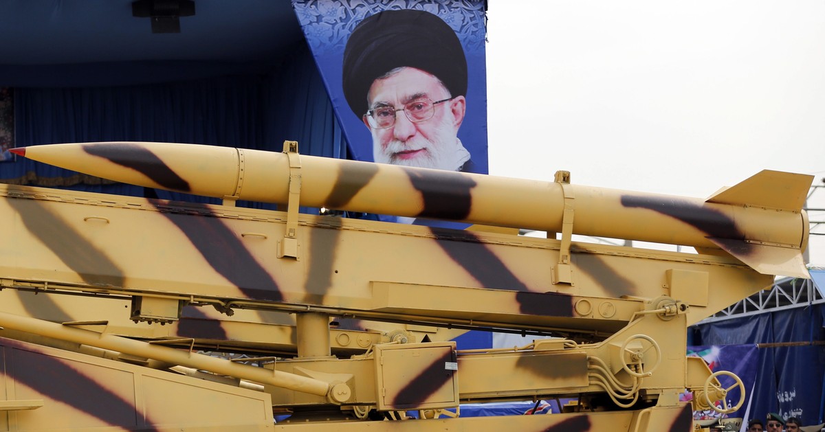 epa04171122 An Iranian mid-range missile 'Zelzal' is driven by a huge poster of Iranian supreme leader Ayatollah Ali Khamenei during a ceremony marking the annual National Army Day in Tehran ...