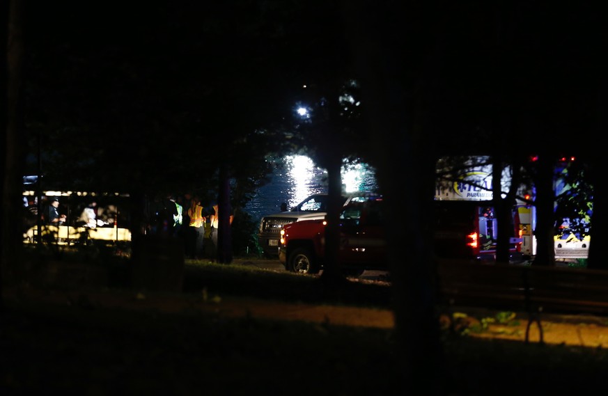 Emergency responders work at Table Rock Lake after a deadly boat accident in Branson, Mo., Thursday, July 19, 2018. A sheriff in Missouri said a tourist boat has apparently capsized on the lake, leavi ...