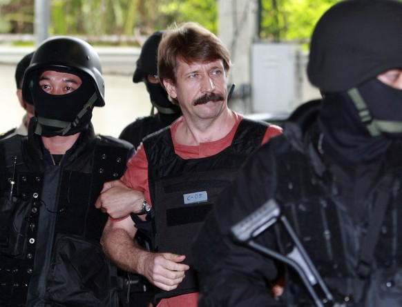 FILE - Viktor Bout, center, is led by armed Thai police commandoes as he arrives at the criminal court in Bangkok, Thailand, Tuesday, Oct. 5, 2010. The Russian arms dealer who once inspired a Hollywoo ...