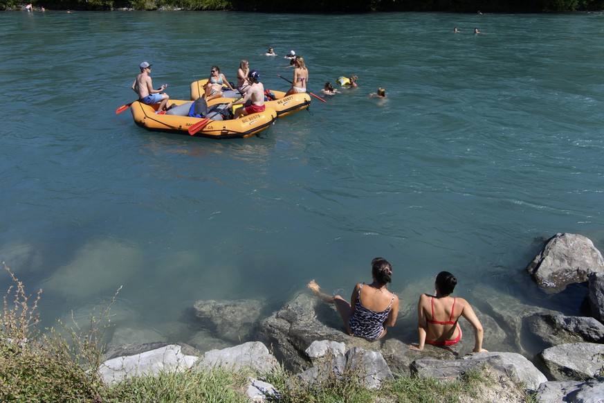 epa08592074 People enjoy a swim in the Aare River during the sunny and warm weather, in Bern, Switzerland, 08 August 2020. EPA/ANTHONY ANEX