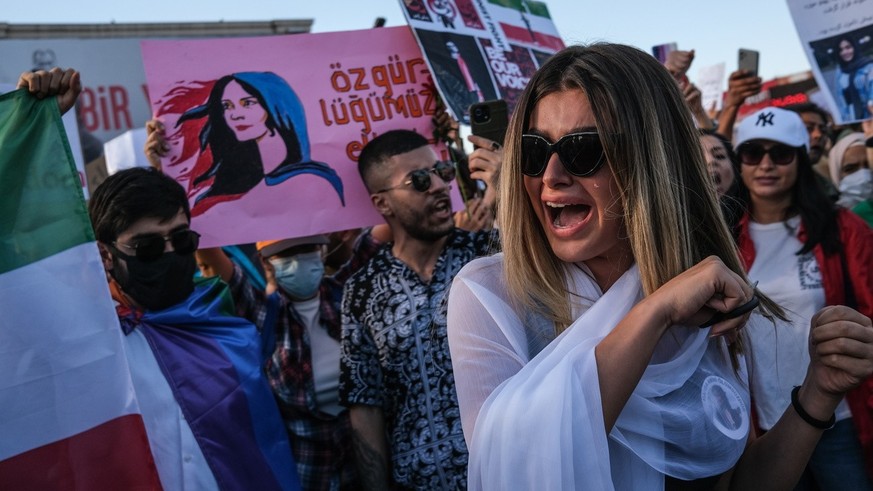 epa10219873 An Iranian woman cuts her hair during a protest following the death of Iranian Mahsa Amini, in Istanbul, Turkey, 02 October 2022. Amini, a 22-year-old Iranian woman, was arrested in Tehran ...