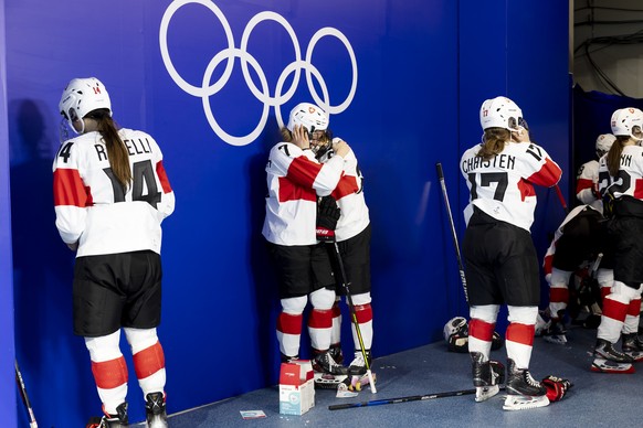 Switzerland&#039;s forward Lara Stalder #7 and Switzerland&#039;s forward Alina Mueller, comfort each after losing the women&#039;s ice hockey Bronze Medal game between Finland and Switzerland at the  ...