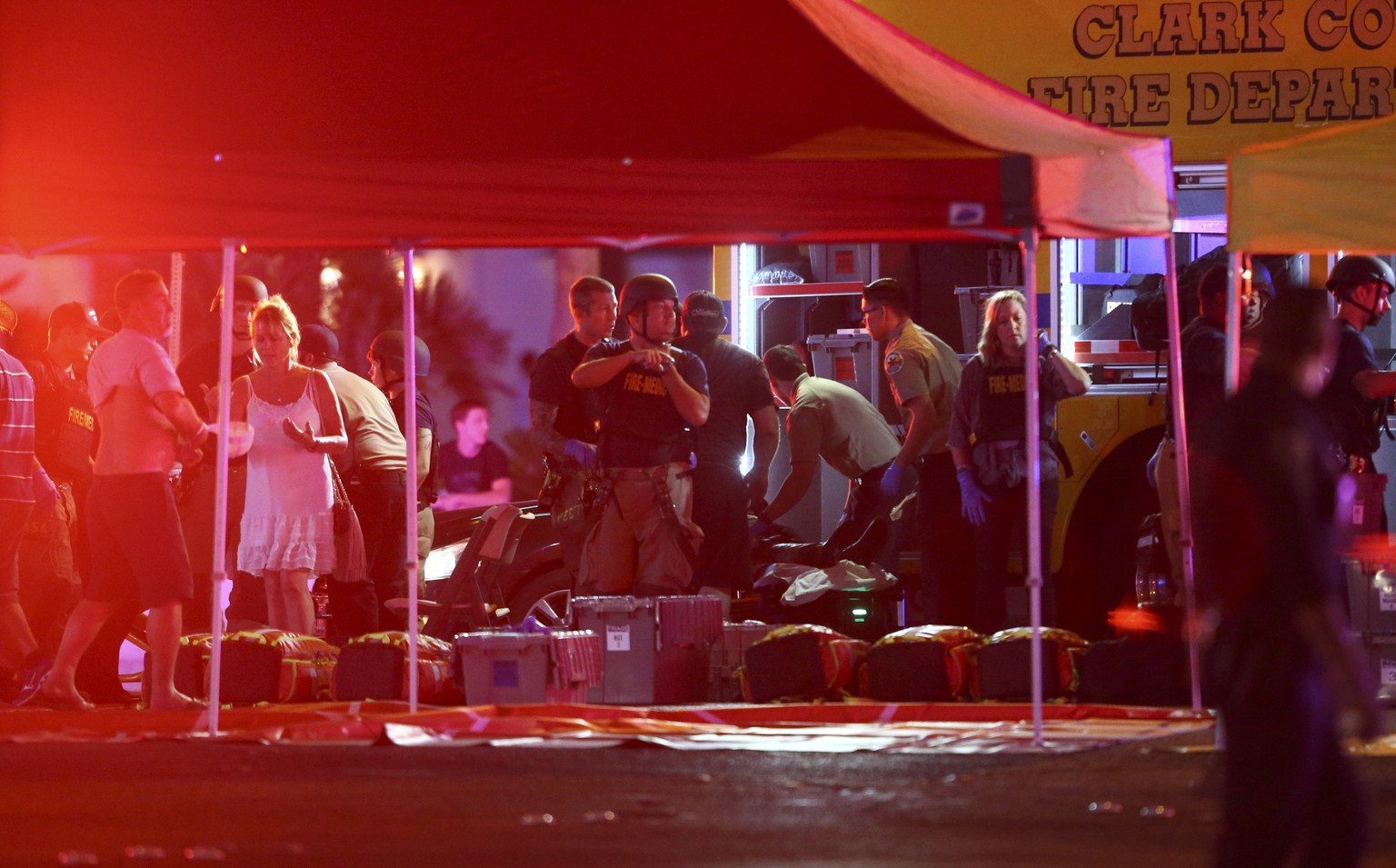 FILE - In this Sunday, Oct. 1, 2017 file photo, medics treat the wounded as Las Vegas police respond during an active shooter situation on the Las Vegas Strip in Las Vegas. The deadly shooting from a  ...