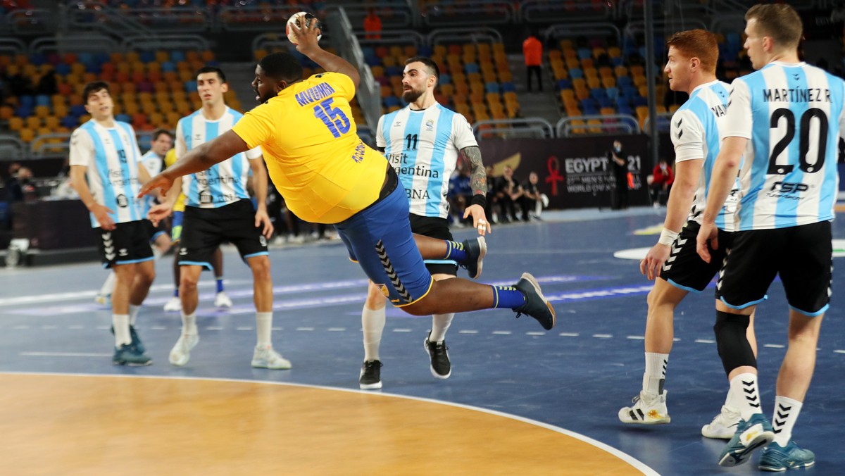 epa08939665 Gauthier Mvumbi Thierry (C) of Congo attempts to score during the match between Argentina and D.R. Congo at the 27th Men's Handball World Championship in Cairo, Egypt, 15 January 2021 ...