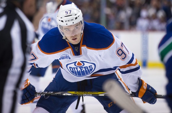 Edmonton Oilers' Connor McDavid lines up for a faceoff against the Vancouver Canucks during the first period of an NHL hockey game Saturday, April 9, 2016, in Vancouver, British Columbia. (Darryl ...