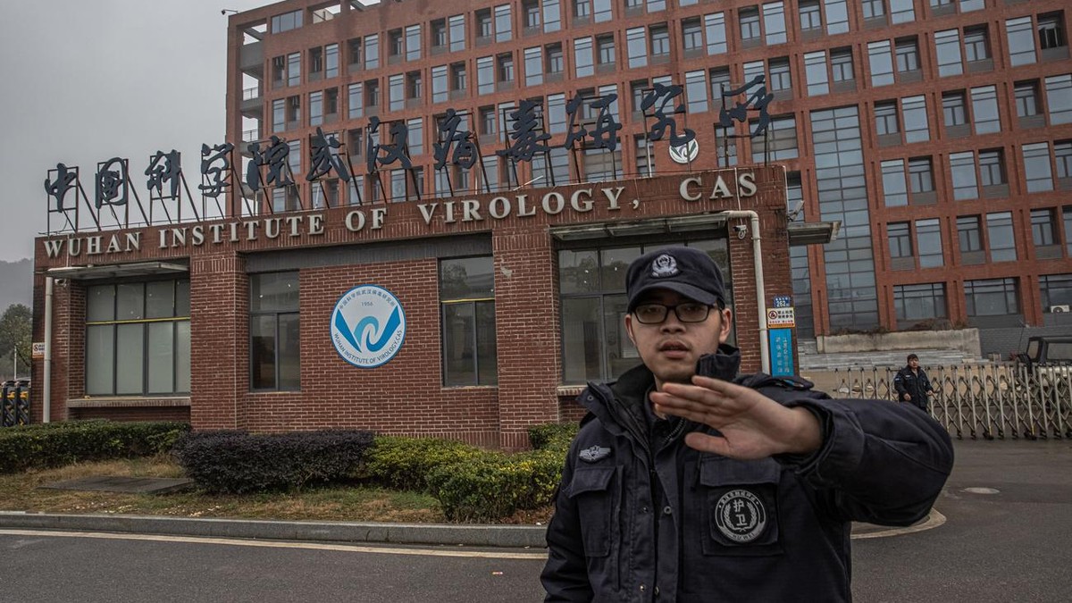 epa08968097 A security staff tries to stop the photographer from taking pictures of Wuhan Institute of Virology in Wuhan, China, 27 January 2021. The international expert team from the World Health Or ...
