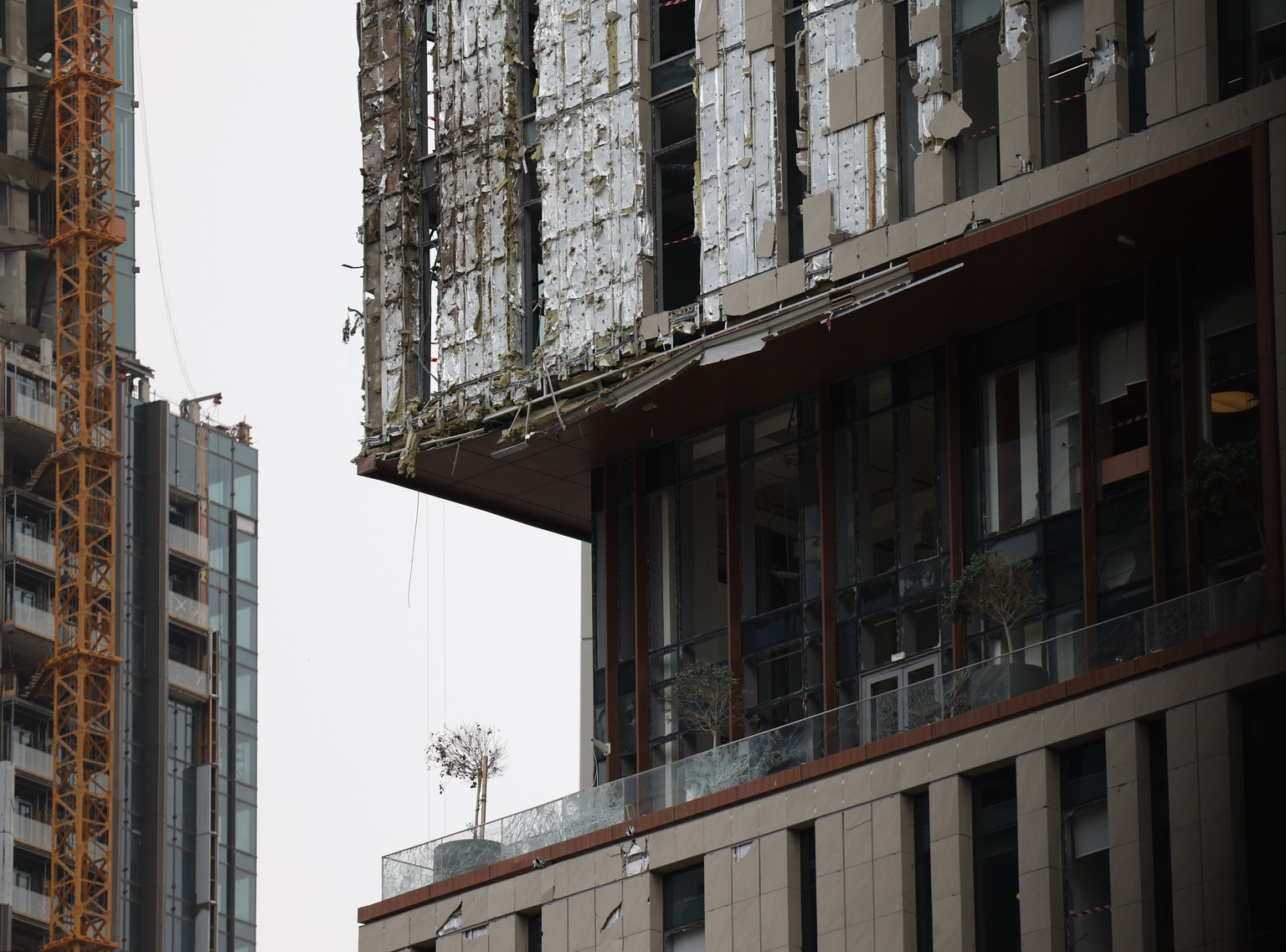 epaselect epa12816912 A view of the damaged part of one of the buildings of Dubai International Financial Centre (DIFC) caused by debris from an interception of an Iranian drone attack in Dubai, Unite ...