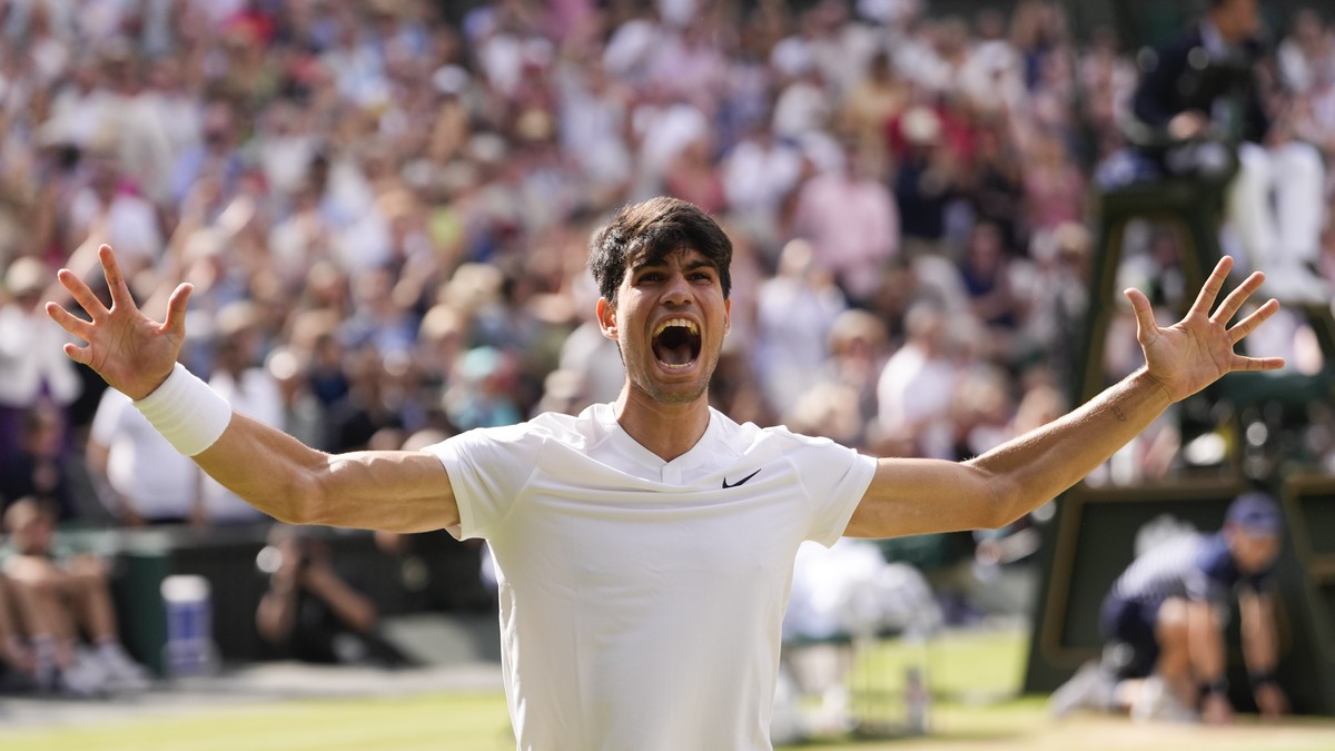 Carlos Alcaraz of Spain celebrates after defeating Novak Djokovic of Serbia in the men's singles final at the Wimbledon tennis championships in London, Sunday, July 14, 2024. (AP Photo/Alberto Pe ...
