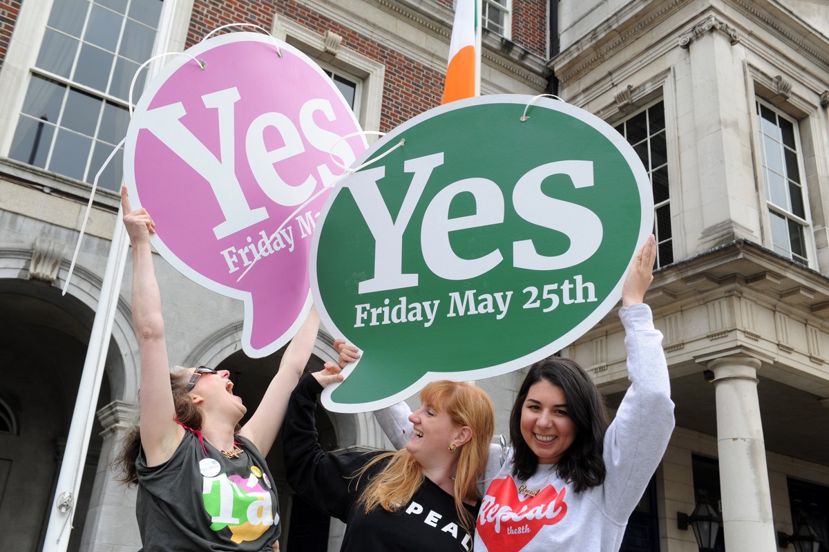 epa06764672 Women celebrate with Yes vote signs after a referndum on abortion, in Dublin, Ireland, 26 May 2018. Ireland has voted overwhelmingly to legalize abortion in a historic referendum on 25 May ...