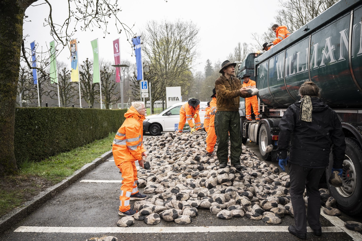 epa09863185 Protestors hold a demonstration on the day of the official draw for the FIFA World Cup Qatar 2022, at the FIFA headquarters in Zurich, Switzerland, 01 April 2022. At dawn, German artist Vo ...