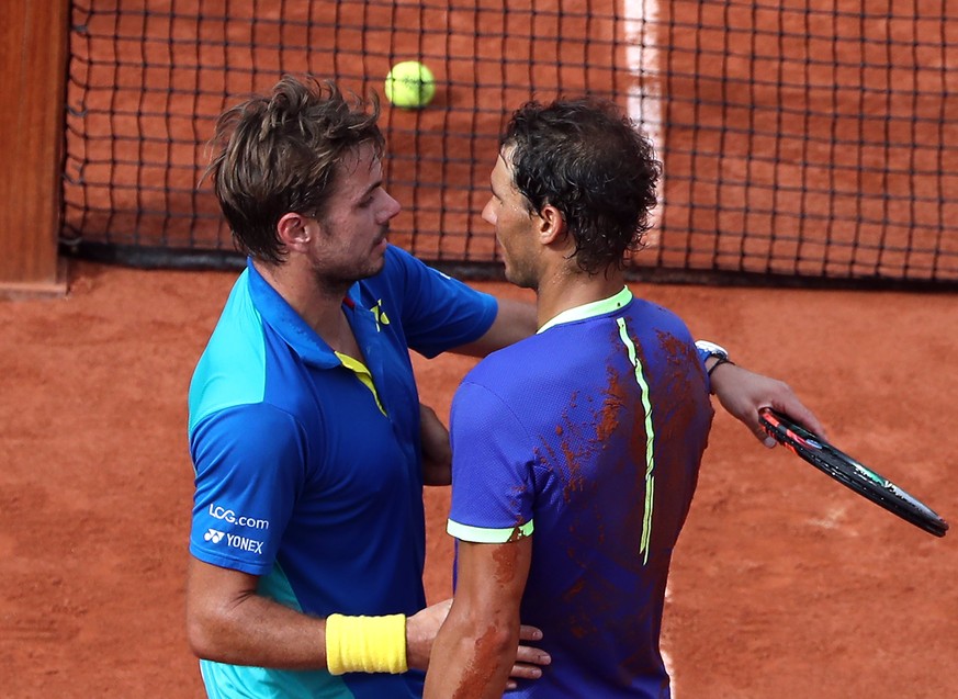 epa06022883 Rafael Nadal of Spain (R) reacts after winning the men’s singles final match against Stanislas Wawrinka of Switzerland during the French Open tennis tournament at Roland Garros in Paris, F ...