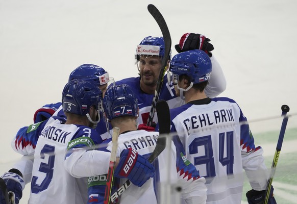 Slovakia&#039;s team players celebrate a goal during the Ice Hockey World Championship group A match between the Belarus and Slovakia at the Olympic Sports Center in Riga, Latvia, Friday May 21, 2021. ...