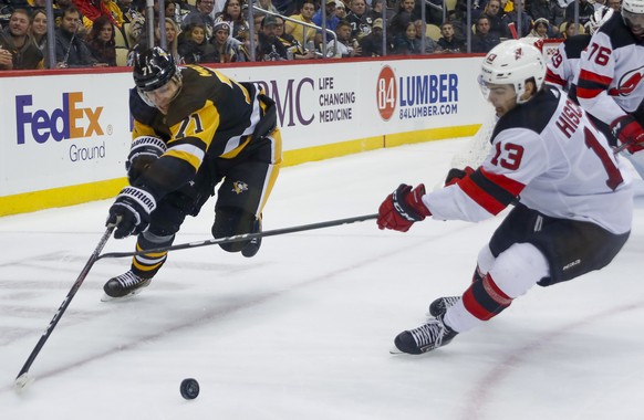 Pittsburgh Penguins&#039; Evgeni Malkin (71) and New Jersey Devils&#039; Nico Hischier (13) chase after the puck during the second period of an NHL hockey game, Friday, Nov. 22, 2019, in Pittsburgh. ( ...