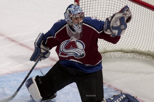 Colorado Avalanche back-up goalie David Aebischer reaches out to stop a shot off the stick of the Vancouver Canucks in the first period in Denver on Thursday, Oct. 25, 2001. Aebischer, who is from Swi ...