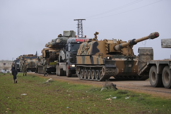 Turkish military convoy is seen near the town of Idlib, Syria, Wednesday, Feb. 12, 2020. Turkish President Recep Tayyip Erdogan said Wednesday that Turkey will attack government forces anywhere in Syr ...