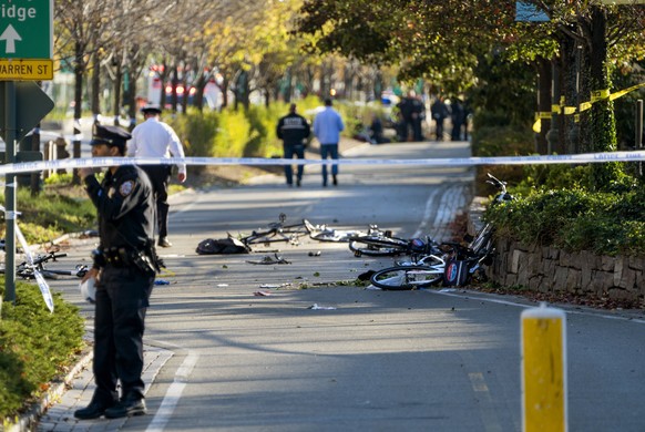 Bicycles and debris lay on a bike path after a motorist drove onto the path near the World Trade Center memorial, striking and killing several people Tuesday, Oct. 31, 2017, in New York. (AP Photo/Cra ...