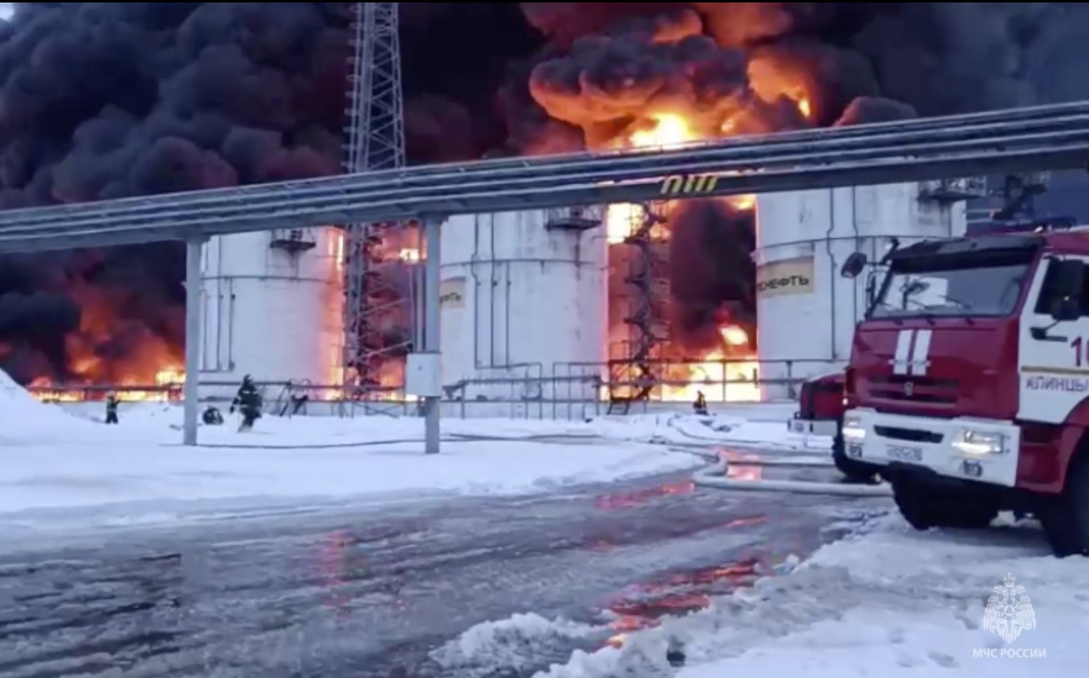 epa11089525 A still image taken from a handout video provided � by the Russian Emergencies Ministry Press-Service shows Russian firefighters extinguishing a fire following a reported drone attack on t ...