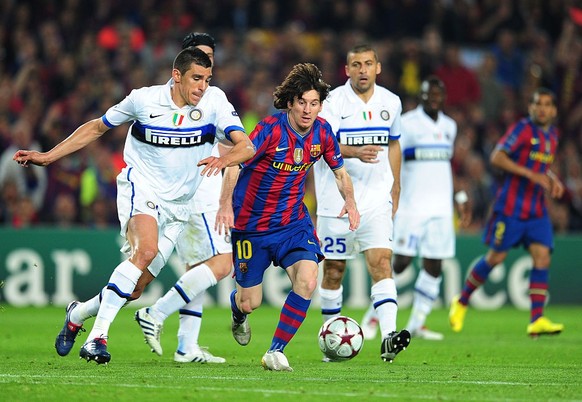 Lionel Messi of Barcelona and Lucio of Inter Milan during the UEFA Champions League Semi Final 2nd Leg match between Barcelona and Inter Milan at the Nou Camp Stadium in Barcelona, Spain. | Location:  ...