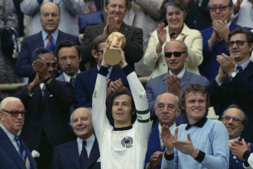 FILE - West Germany captain, Franz Beckenbauer holds up the World Cup trophy after his team defeated the Netherlands 2-1, in the World Cup final soccer match at Munich's Olympic stadium, in West ...