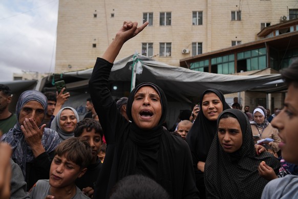Palestinians celebrate following the announcement that Israel and Hamas have agreed to the first phase of a peace plan to pause the fighting, outside Al-Aqsa Hospital in Deir al-Balah, central Gaza St ...