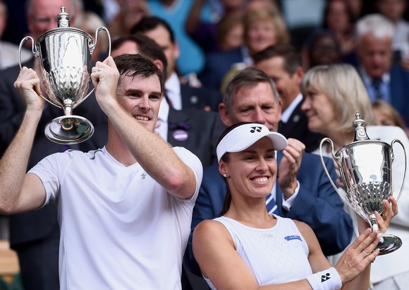epa06091659 Martina Hingis (R) of Switzerland and Jamie Murray (L) of Britain celebrate with their trophies after winning against Heather Watson of Britain and Henri Kontinen of Finland during their M ...