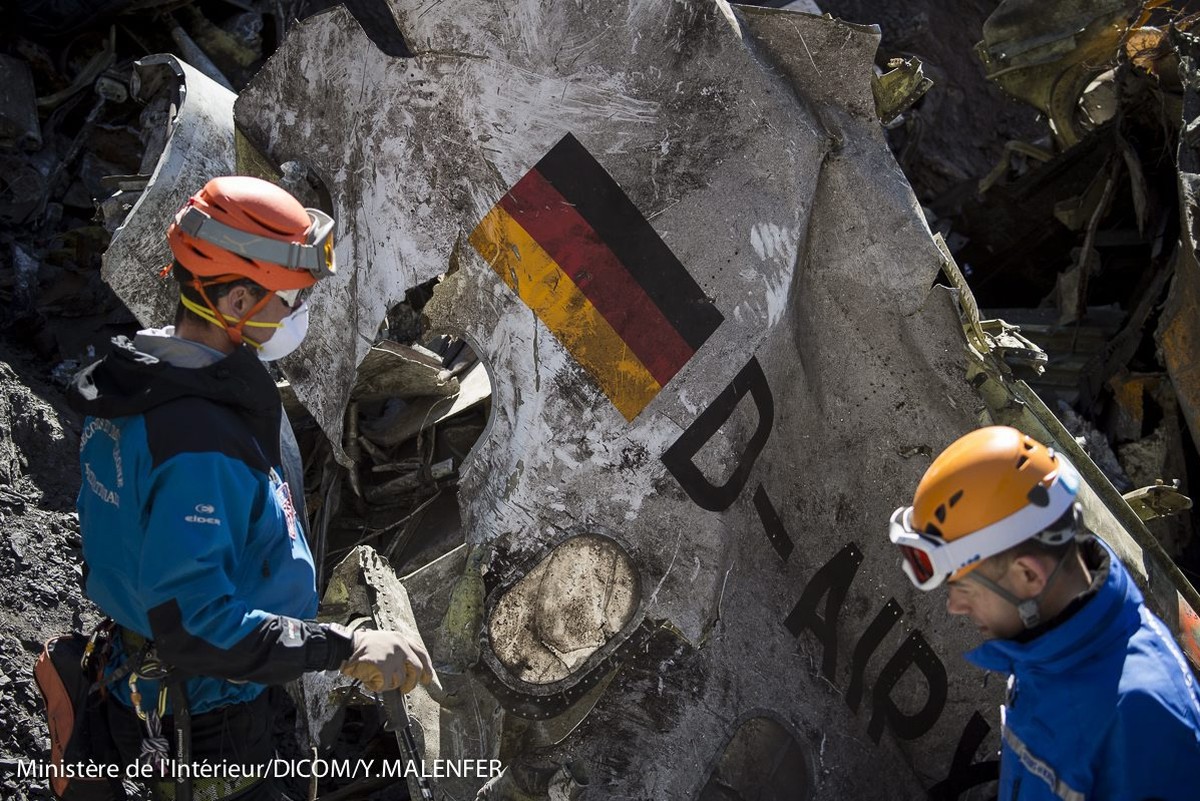 epa04688872 A handout photo made available by the French Interior Ministry on 01 April 2015 shows search and rescue workers collecting debris at the crash site of the Germanwings Airbus A320 in the Fr ...