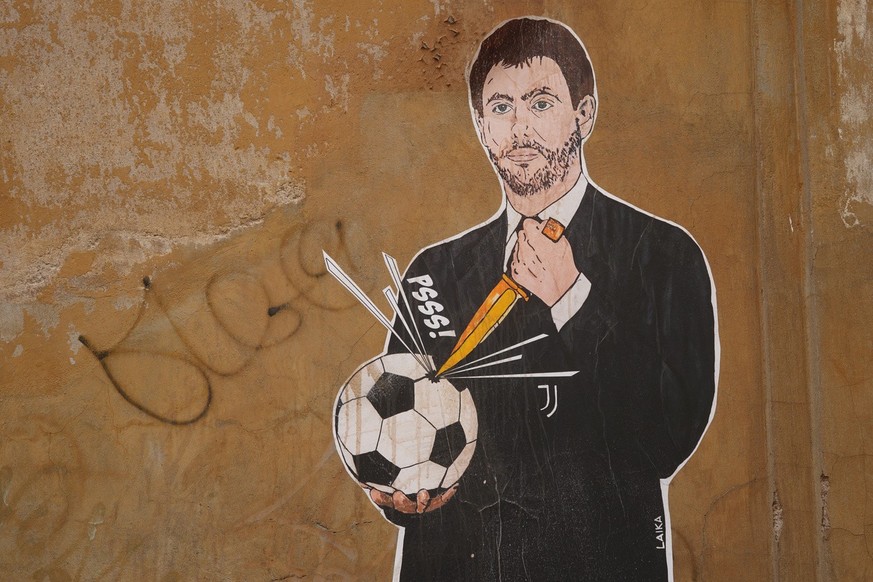 A mural depicting Juventus president Andrea Agnelli making a hole in a football with a knife, appeared in Rome, Thursday, April 22, 2021. Juventus was one of the three Italian soccer clubs among the f ...